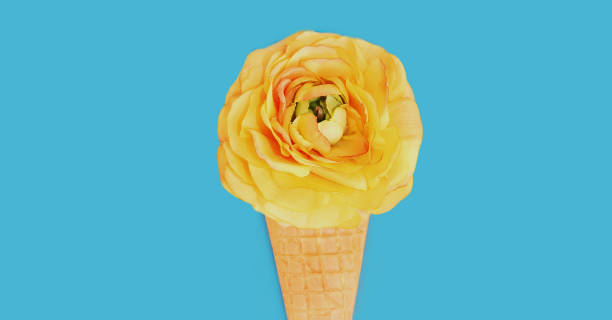 istock Cone with pink flowers as ice cream over a blue background 1287487839