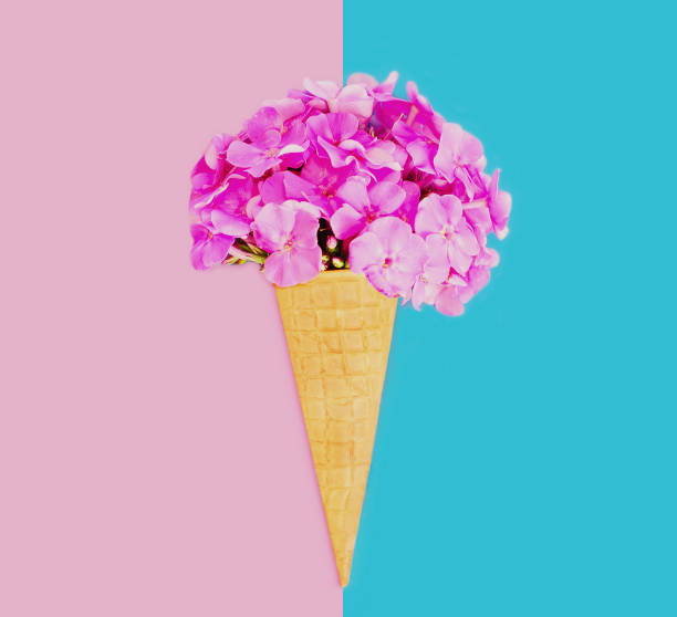 istock Cone with pink flowers as ice cream over a blue background 1287487853