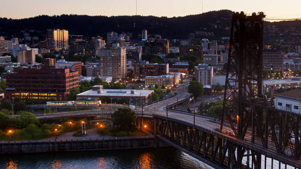 istock Light Rail Train Leaving Downtown Portland Over Steel Bridge - Aerial 1287488554