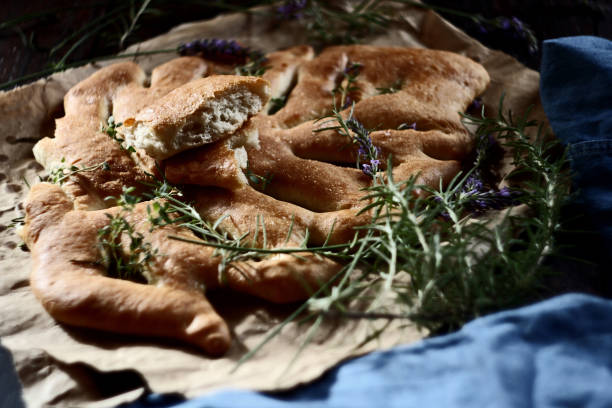 istock Fougasse, traditional french bread on wooden background. Selective focus 1287491721