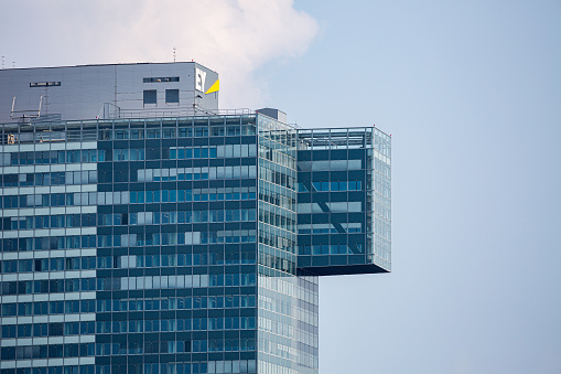 Vienna, Austria - July 31: Logo of Ernst & Young Global Limited,  or simply EY on glass facade of building of the IZD Tower in Vienna Donau city in Vienna, on July 31, 2019.
