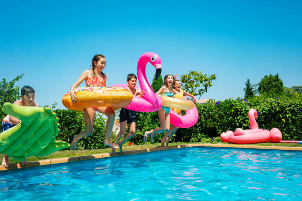 istock Children with inflatable toys dive swimming pool 1287494066