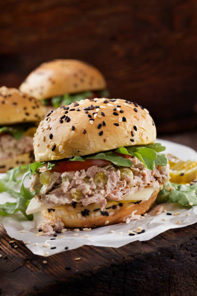 Creamy Tuna Salad Sliders with Sweet Pickles, Swiss Cheese, Tomato and Arugula on Brioche Sesame Seed Buns