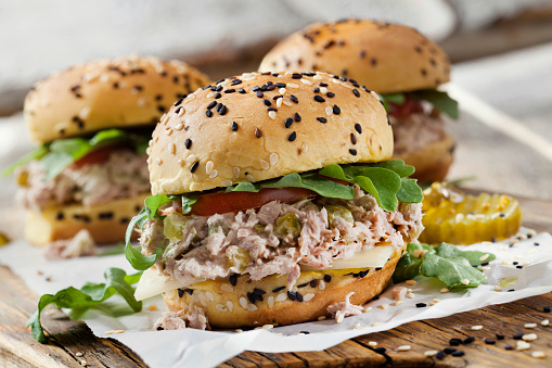 Creamy Tuna Salad Sliders with Sweet Pickles, Swiss Cheese, Tomato and Arugula on Brioche Sesame Seed Buns