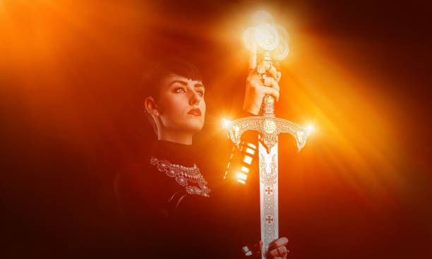 istock Strong, confident woman raising sword 1287499437