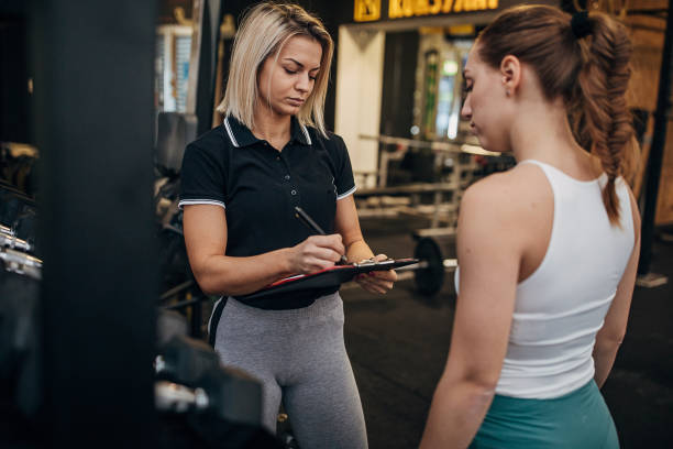 istock Female personal trainer arranging trainings for a woman 1287499676