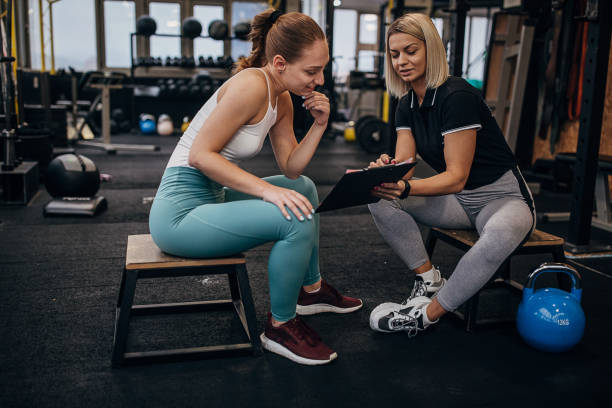 istock Female personal trainer arranging trainings for a woman 1287499687