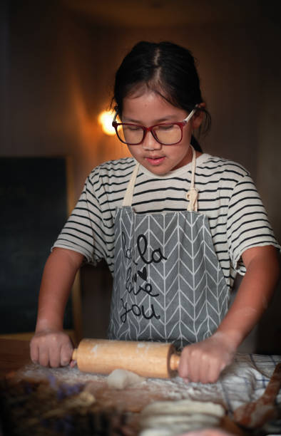 istock The girl flattened the dough with rolling pin 1287499889