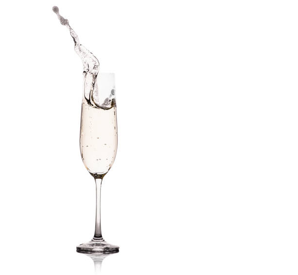Glasses of champagne with splash, isolated on white background.