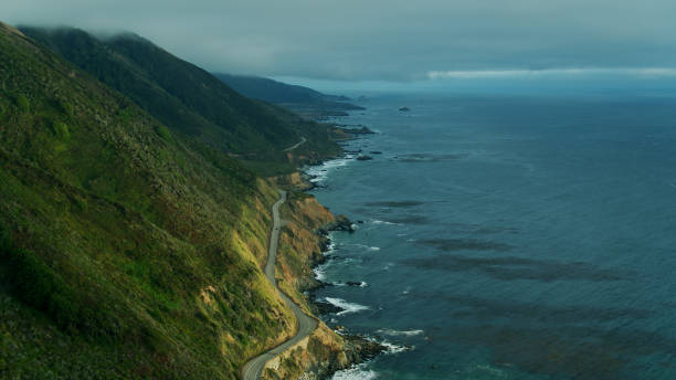 istock Car Heading South Through Big Sur - Aerial 1287505357