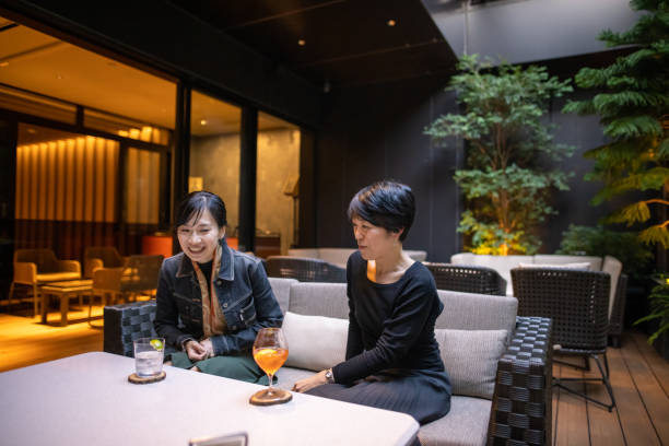 istock Asian women relaxing at open cafe with alcohol after work 1287506346