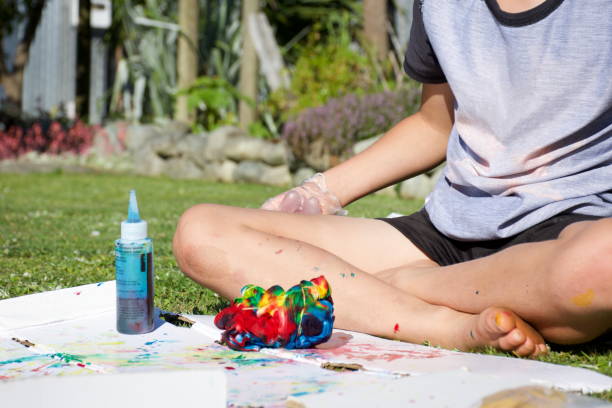 istock Child Making Tie Dye T-Shirt 1287515857