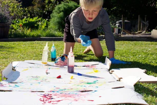 istock Child Making Tie Dye T-Shirt 1287516576