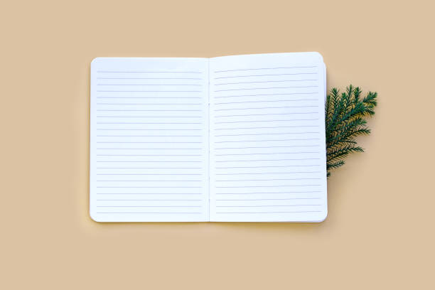 istock Notebook with green leaves on pastel background. 1287517230