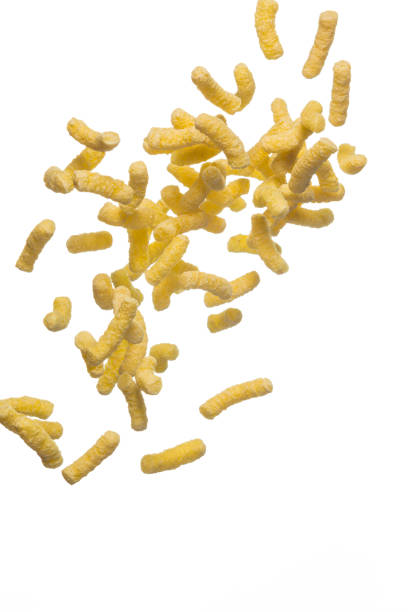 istock Plenty of Flying Popcorn Flakes isolated Over White Background. Vertical image Composition 1287520823