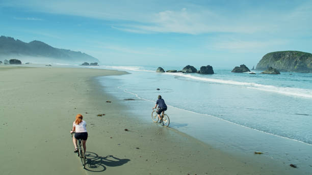 istock Drone Shot Behind Cyclists on Whaleshead Beach, Oregon - Aerial 1287527108