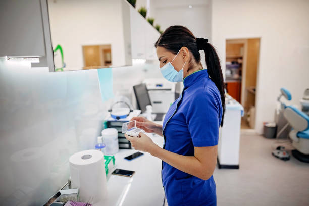 Dental nurse preparing medicine for surgery