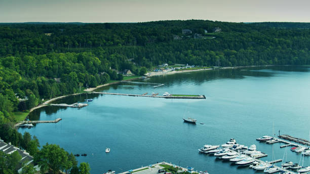 istock Sailboat Passing Marina of Egg Harbor, Wisconsin 1287532416