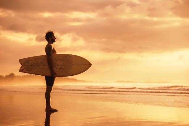 istock Attractive sporty real surfer at sunset ocean beach 1287533401