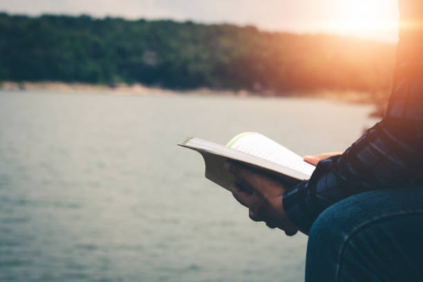 istock Men read book in the holiday in quiet nature, Concept reading a book. 1287535206