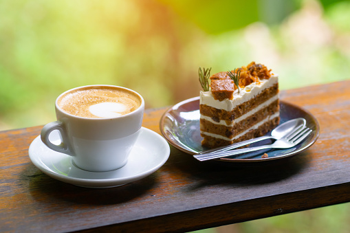 Coffee and cake on wood table, At Morning time in happy day travel trip. Food and travel concept.