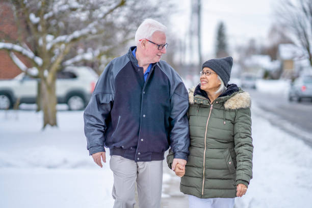 istock Senior Couple Walking Outside 1287536256