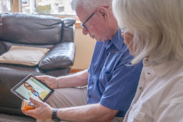 istock Senior couple speaking with their doctor via video chat 1287537986
