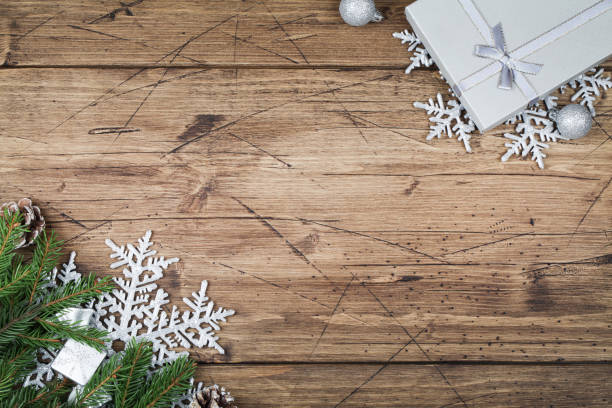istock fir branches , gift , cones, snowflakes and balls on brown wooden background, top view flat lay copy space. Christmas and New Year background 1287539941