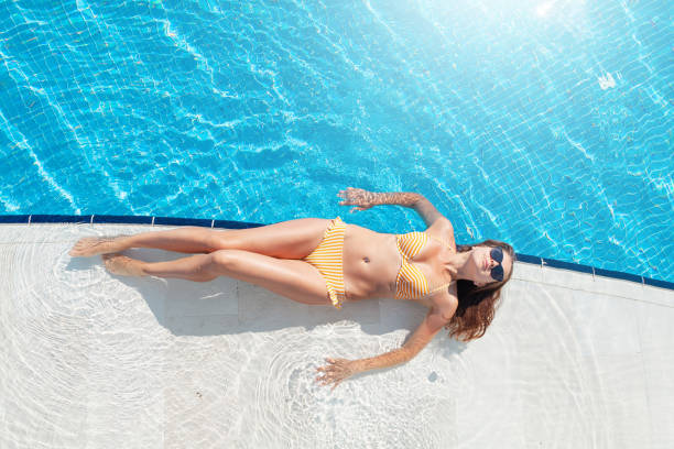 istock Woman relaxing in swimming pool 1287543092