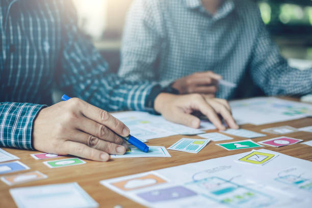 istock Team of website designers who are creative and planning to develop an application on the mobile phone in the office. 1287546573