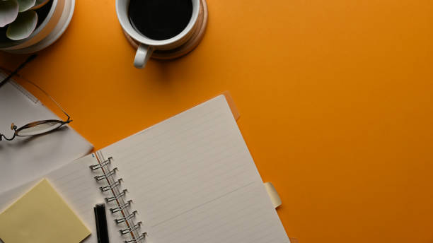 istock Workspace with notebooks, stationery, coffee cup and copy space in home office room 1287547582