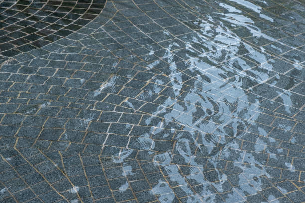 istock texture of a stone floor with running water, nature background. 1287547742
