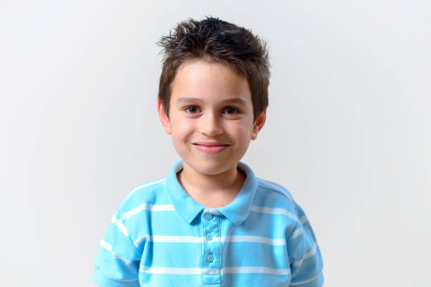 istock A boy in a blue T-shirt smiles looking into the camera. 1287547780
