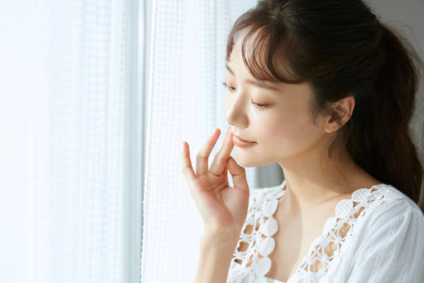Natural portrait of young Asian woman by the window skin care, beauty portrait japanese woman stock pictures, royalty-free photos & images