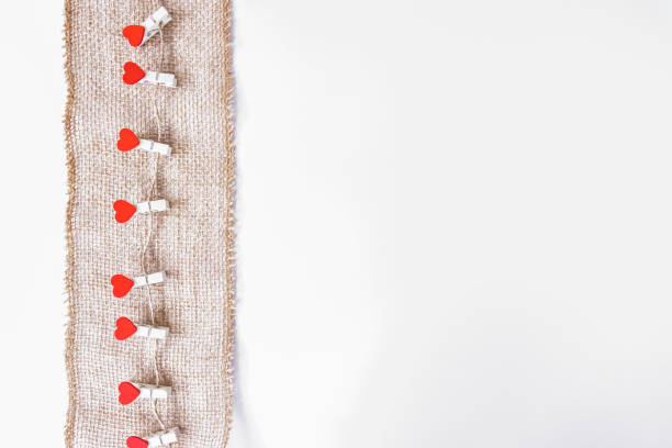 istock Red hearts hang on a brown string as a decoration for Valentine's Day 1287553120