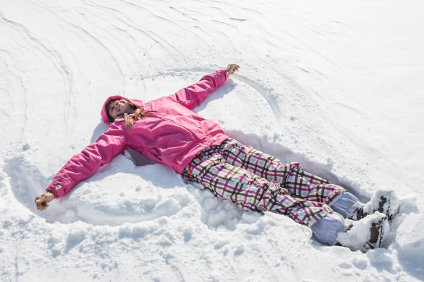 istock young woman lying on the snow 1287555514