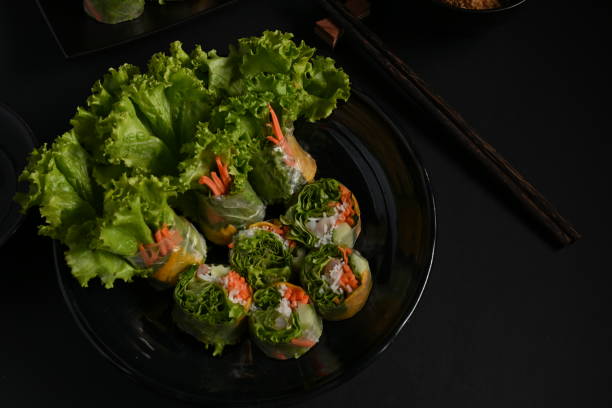 istock Top view of Vietnamese spring rolls and vegetable in dark background 1287555785