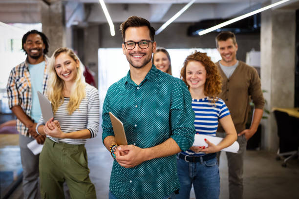 istock Successful company with happy employees in modern office 1287557063