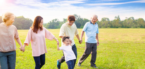 istock three generation asian family walking  in the park 1287558128