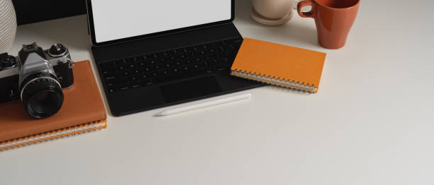 istock Worktable with tablet, camera, stationery and copy space in home office room 1287559016