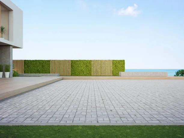 Photo of Beach house with empty cobblestone floor for car park.