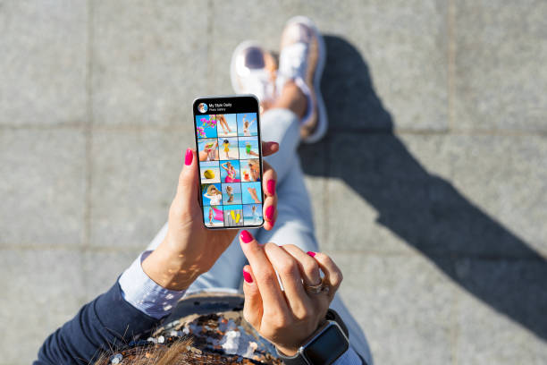 Woman viewing photo gallery posted on social media Woman viewing someone's photo gallery posted on social media auto post production filter stock pictures, royalty-free photos & images