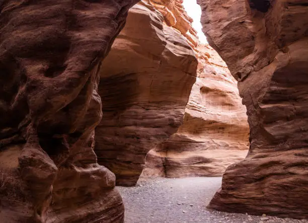 View on a path among stone walls in Timna park located in Negev desert in Israel.