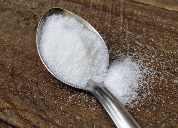 istock A spoon of salt on wooden background 1287566969