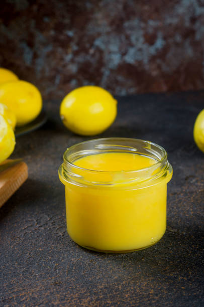 istock Lemon Kurd in a glass jar on dark background 1287568177
