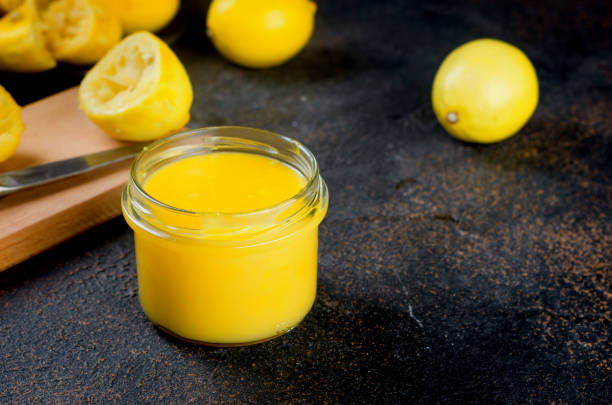 istock Lemon Kurd in a glass jar on dark background 1287568180