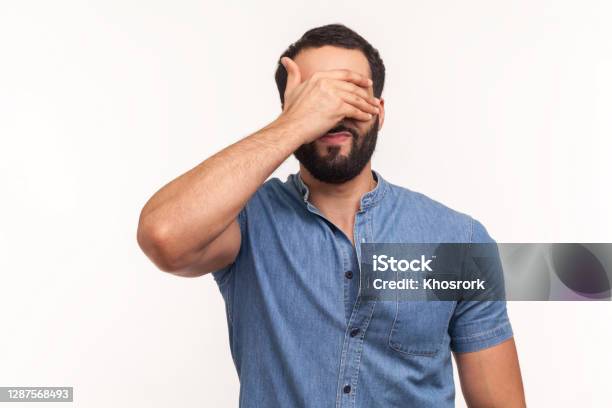 Bearded Man In Blue Shirt Closing Eyes With Hand Dont Want To See That Ignoring Problems Hiding From Stressful Situations Stock Photo - Download Image Now