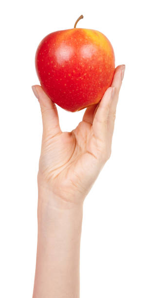 istock Hand with fresh red apple isolated on white background. 1287569637