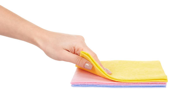 istock Hand with colored cleaning rag isolated on white background. 1287569791