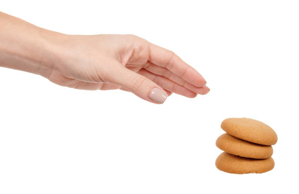 istock Hand with home made cookie isolated on white background. 1287569872
